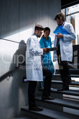 Doctors and nurse looking at digital tablet