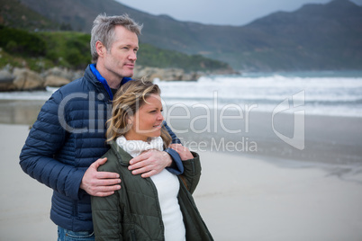 Romantic couple embracing each other on beach