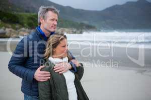 Romantic couple embracing each other on beach