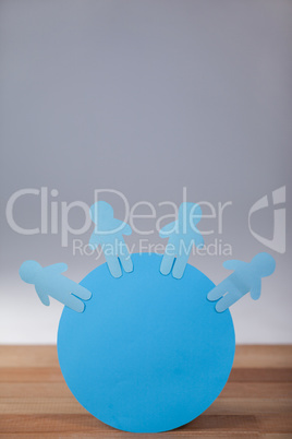 Blue paper cut-out people on the circle