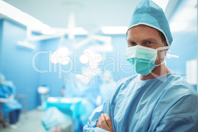 Portrait of male surgeon wearing surgical mask in operation theater