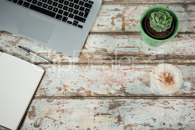 Laptop and diary with cup of coffee