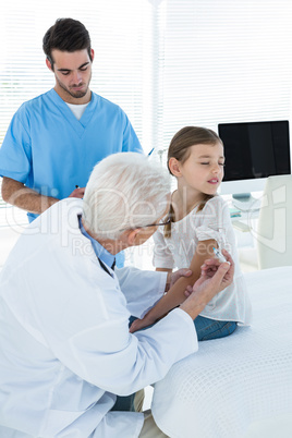 Doctor giving an injection to the patient