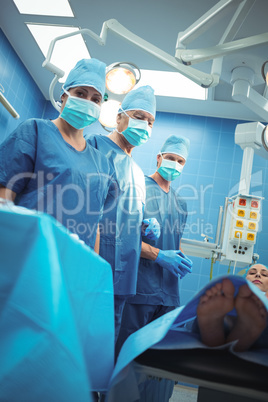 Team of surgeons performing operation in operation theater