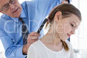 Doctor examining patient neck