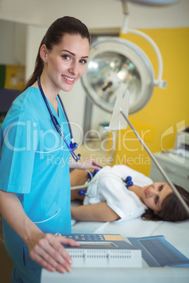 Nurse performing an electrocardiogram test on the patient