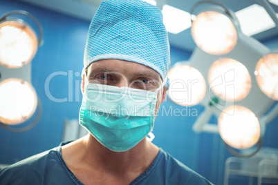 Portrait of male surgeon wearing surgical mask in operation theater