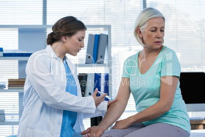 Doctor giving injection to patient