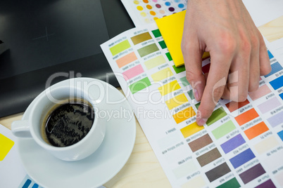 Graphic designer working on graphic tablet at his desk