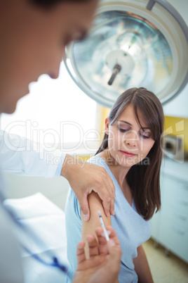 Doctor giving an injection to the patient