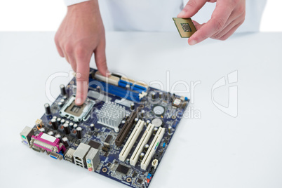 Computer engineer repairing motherboard