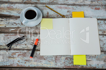 Diary and coffee cup with office accessories