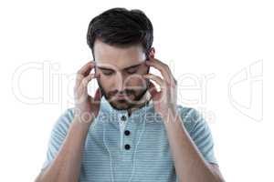 Stressed man listening to headphones