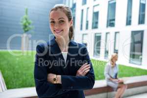 Smiling businesswoman standing in office premises
