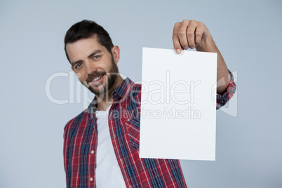 Confident man holding a blank placard