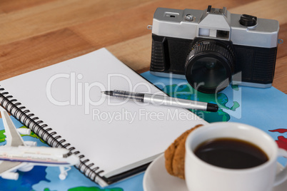 Holiday and tourism conceptual image with travel accessories and cup of coffee