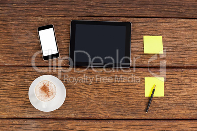 Digital tablet, smartphone and adhesive notes with a cup of coffee