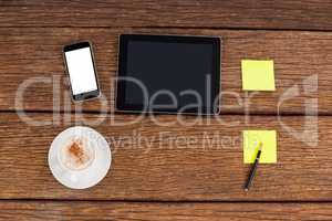 Digital tablet, smartphone and adhesive notes with a cup of coffee