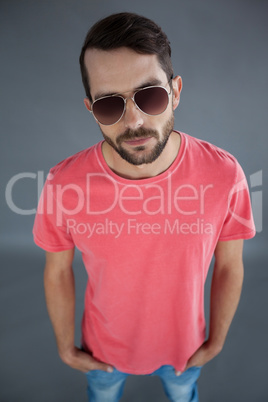 Handsome man in pink t-shirt and sunglasses