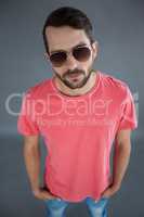 Handsome man in pink t-shirt and sunglasses