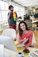 Female graphic designer sitting at desk