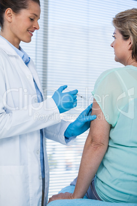 Doctor giving injection to patient