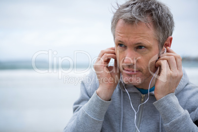 Handsome man listening music on headphones