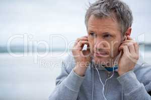 Handsome man listening music on headphones