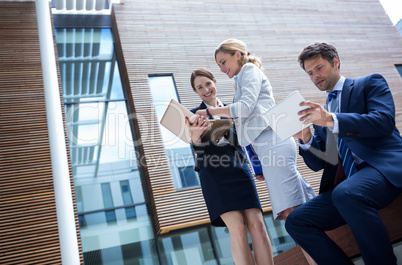 Businesspeople using laptop and digital tablet