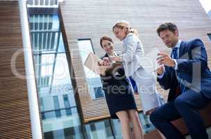 Businesspeople using laptop and digital tablet