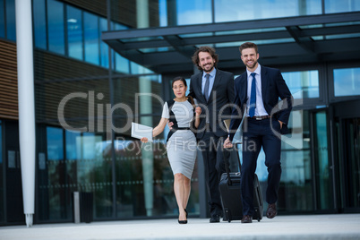 Businesswoman with colleagues walking