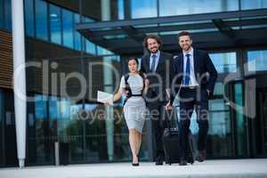 Businesswoman with colleagues walking