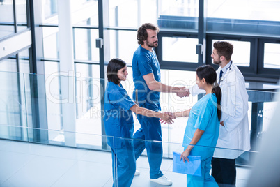 Surgeons, doctor and nurse shaking hands with each other