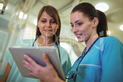 Two female surgeon using digital tablet