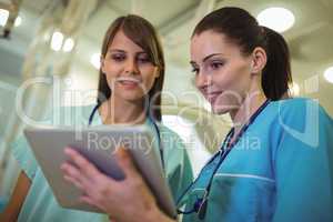 Two female surgeon using digital tablet