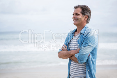 Happy man standing on beach