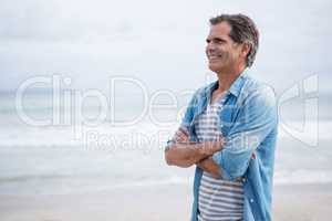 Happy man standing on beach