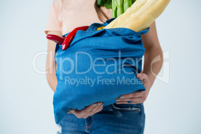 Woman carrying grocery bag