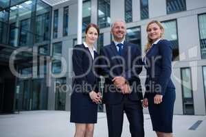 Confident businesspeople standing in the office premises