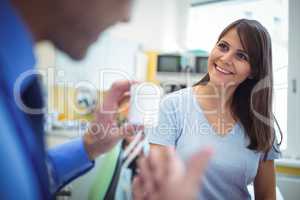 Doctor prescribing medicines to female patient