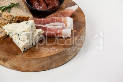 Bread slice, cheese and meat on wooden board