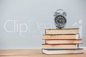 Alarm clock and stack of books