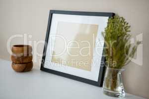 Picture frame with wooden pencil holder and vase