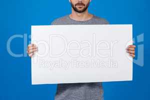 Man holding a blank placard