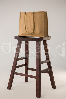 Jute bag on wooden stool