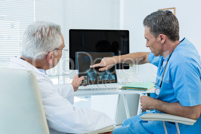 Surgeon and doctor discussing x-ray report