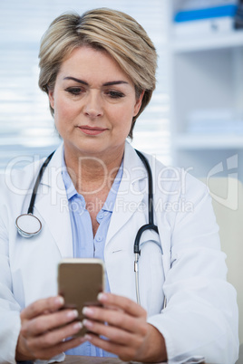 Female doctor using mobile phone