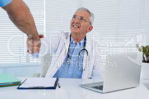 Doctor and surgeon shaking hands