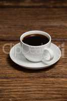 Cup of coffee on wooden table
