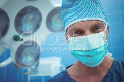 Portrait of male surgeon wearing surgical mask in operation theater